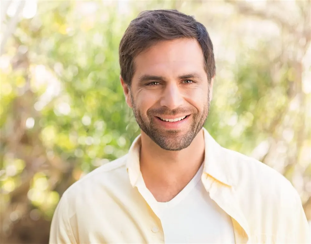 Smiling patient after a gentle tooth extraction